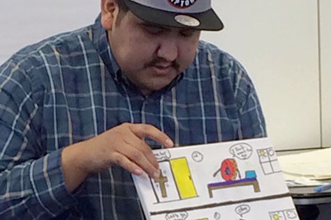 Young person showing small painting on canvas.